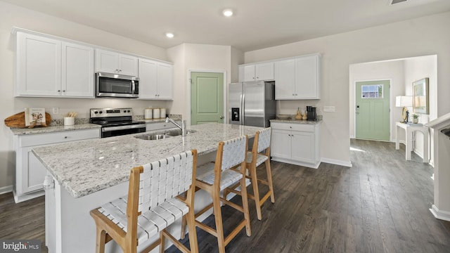 kitchen with white cabinetry, sink, an island with sink, and appliances with stainless steel finishes