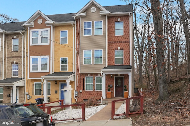 view of property with brick siding and crawl space