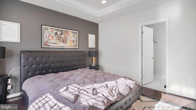 bedroom with recessed lighting, crown molding, baseboards, and wood finished floors