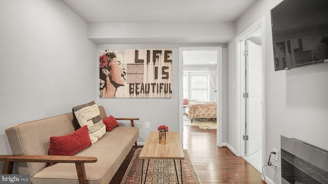 sitting room featuring baseboards and hardwood / wood-style floors