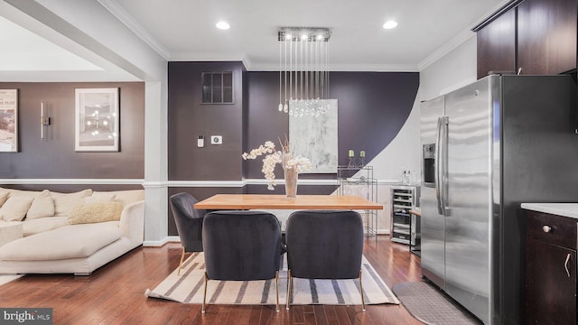 kitchen with wine cooler, crown molding, visible vents, dark wood-type flooring, and stainless steel fridge