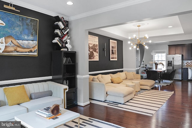 living room with recessed lighting, a notable chandelier, a tray ceiling, dark wood finished floors, and crown molding