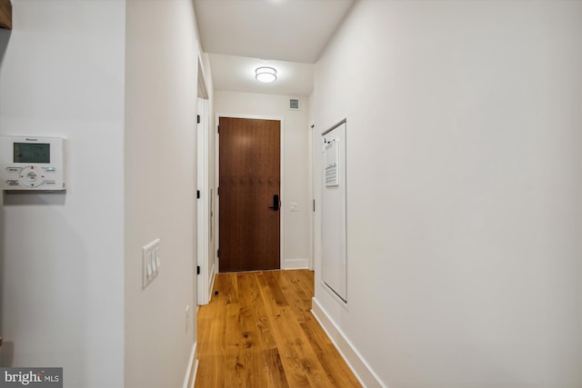 hall with light hardwood / wood-style flooring