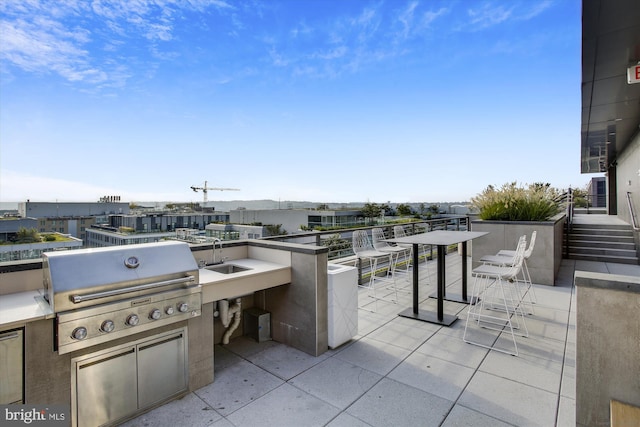 view of patio / terrace featuring area for grilling, grilling area, and a wet bar