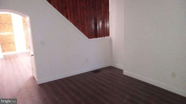 empty room featuring dark hardwood / wood-style flooring