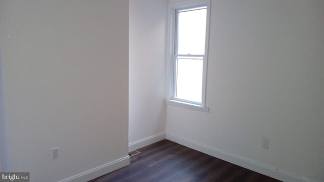 empty room with dark hardwood / wood-style floors