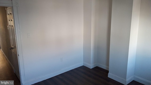 spare room featuring dark hardwood / wood-style flooring