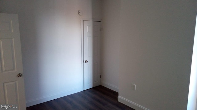 unfurnished bedroom featuring dark hardwood / wood-style floors