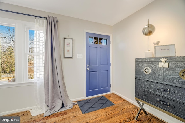 foyer featuring vaulted ceiling and hardwood / wood-style floors