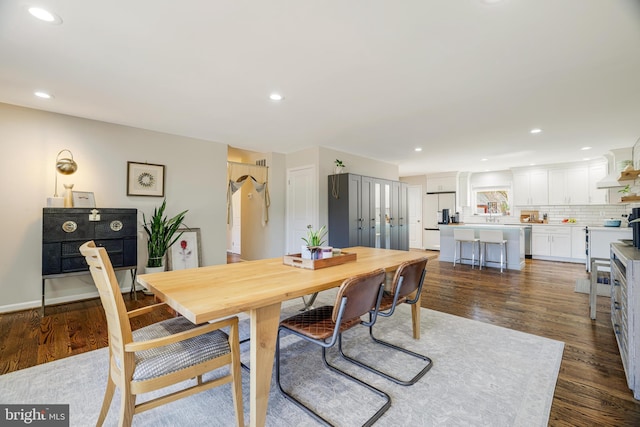 dining space with dark hardwood / wood-style flooring