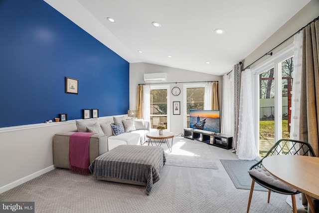 living room featuring a wall mounted AC, light carpet, lofted ceiling, and a healthy amount of sunlight