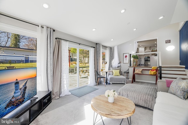 carpeted living room with vaulted ceiling