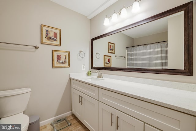 bathroom featuring toilet and vanity