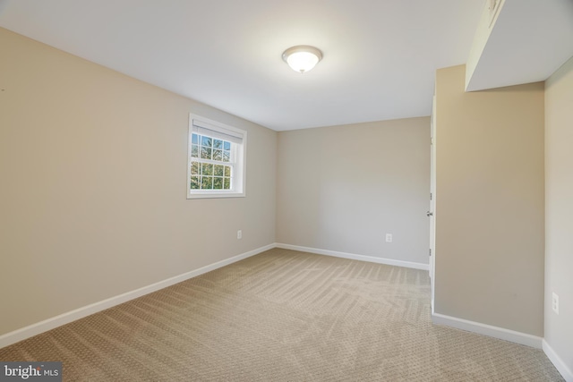 spare room featuring light carpet