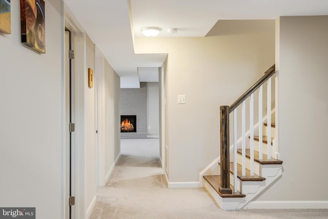 hallway featuring light colored carpet