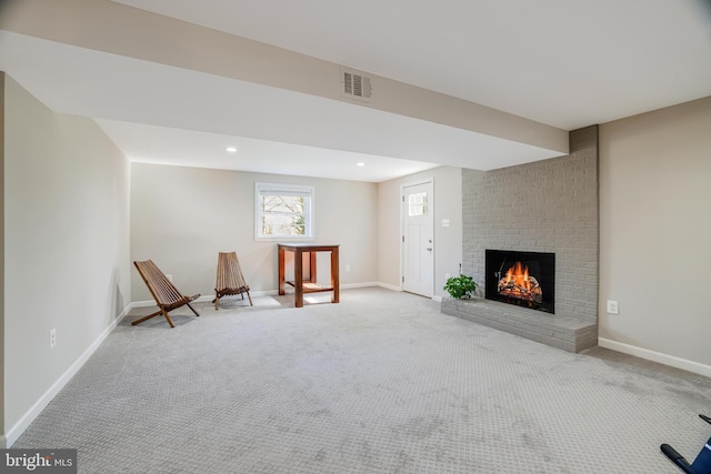 unfurnished room with carpet floors and a brick fireplace