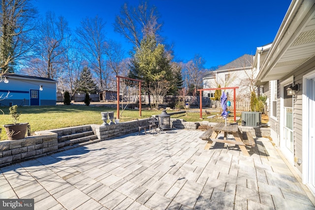 view of patio featuring a playground and central air condition unit