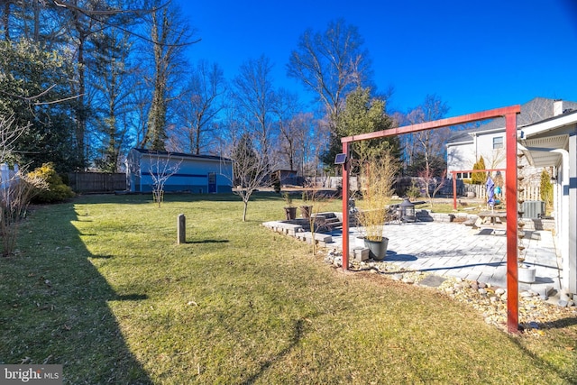 view of yard with central AC and a patio