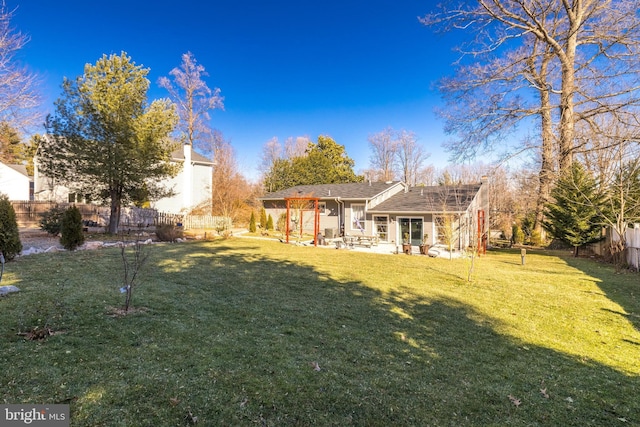 back of house with a lawn and a patio area