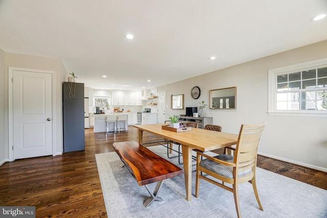 dining area with dark hardwood / wood-style floors