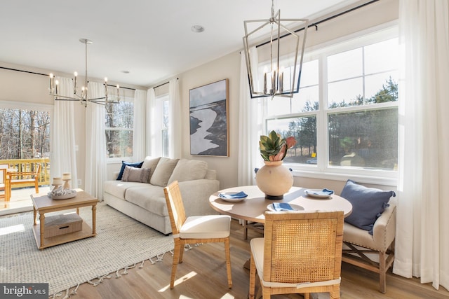 dining space with a chandelier and wood finished floors