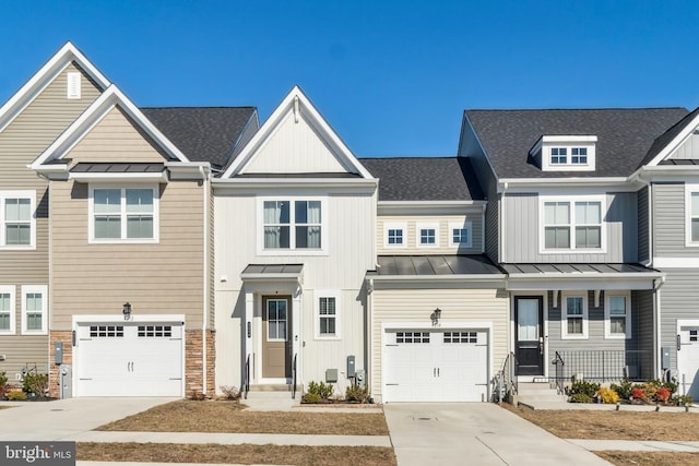 townhome / multi-family property featuring metal roof, an attached garage, a shingled roof, concrete driveway, and a standing seam roof