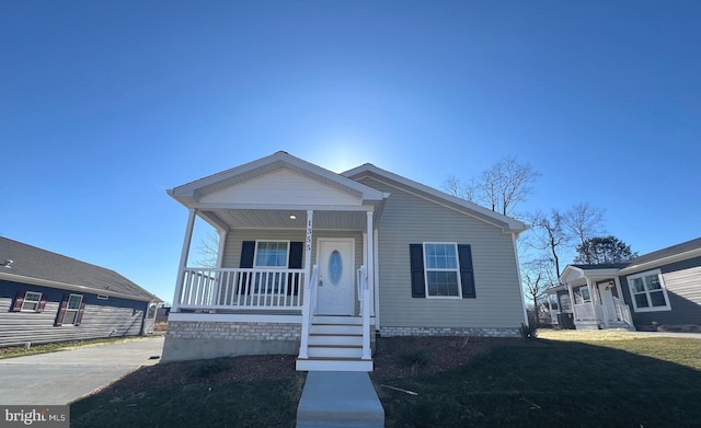 view of front facade featuring a porch, a front lawn, and central air condition unit