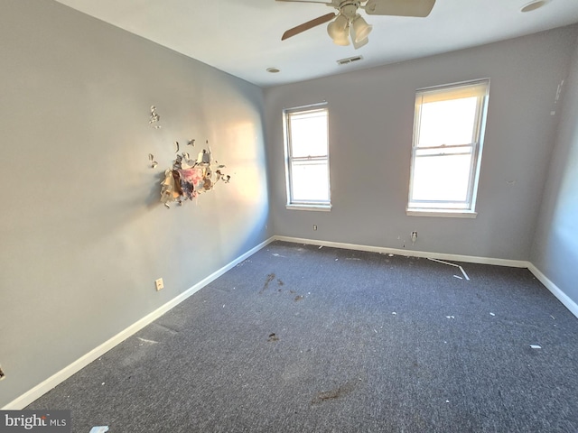 carpeted spare room with ceiling fan