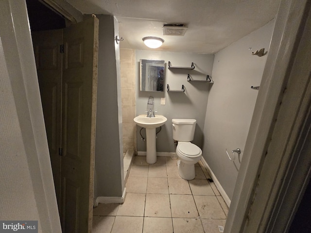 bathroom featuring tile patterned floors, toilet, and sink