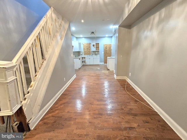 corridor with dark hardwood / wood-style flooring