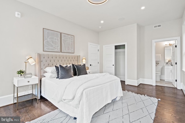 bedroom with dark hardwood / wood-style flooring, a closet, and ensuite bathroom