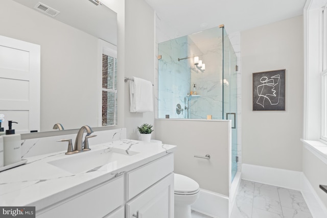 bathroom with vanity, toilet, and an enclosed shower