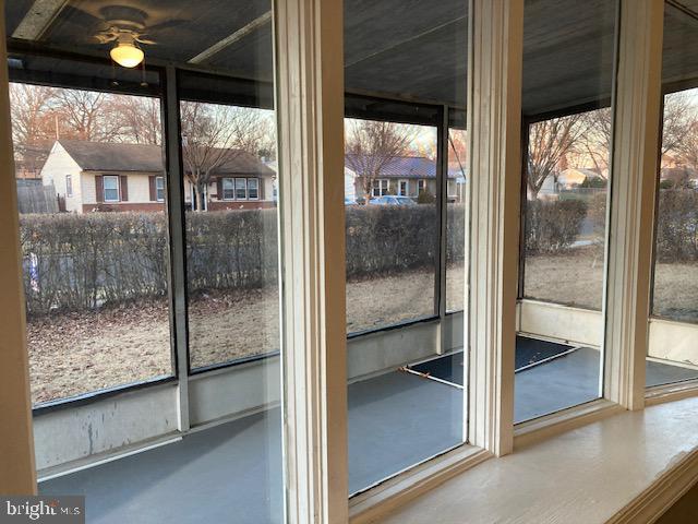 doorway to outside featuring concrete flooring and ceiling fan