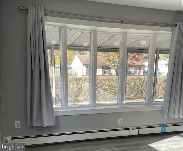 interior details featuring hardwood / wood-style flooring and a baseboard heating unit