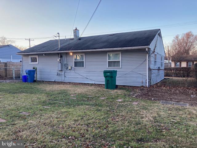 back of house with a yard