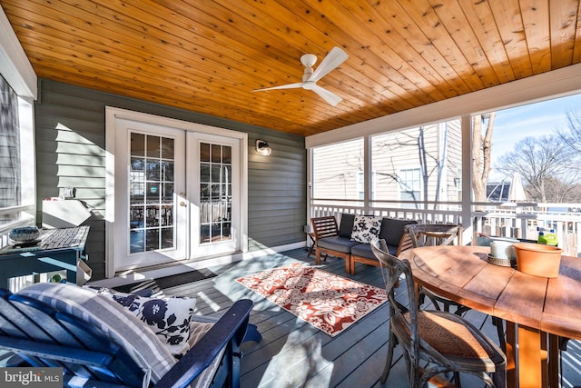 sunroom with wood ceiling, a ceiling fan, and french doors