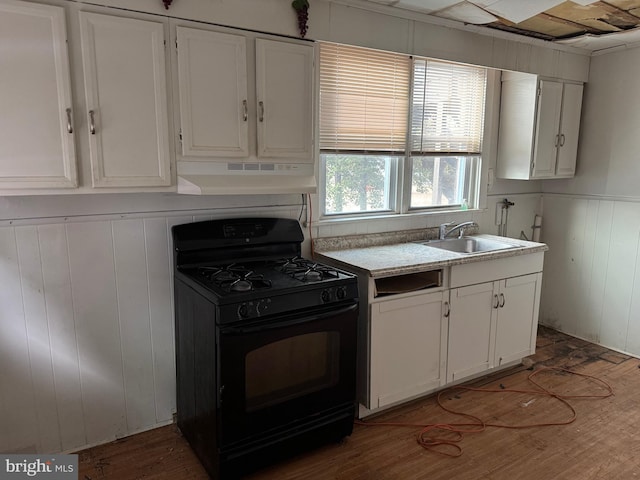 kitchen featuring light countertops, white cabinets, black range with gas cooktop, and under cabinet range hood