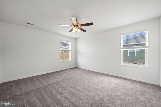 unfurnished room featuring ceiling fan and carpet