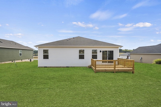 rear view of property featuring a wooden deck and a yard