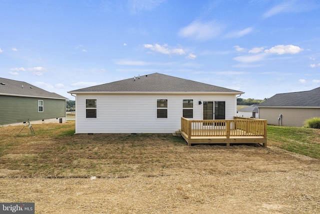 rear view of house featuring a yard and a deck