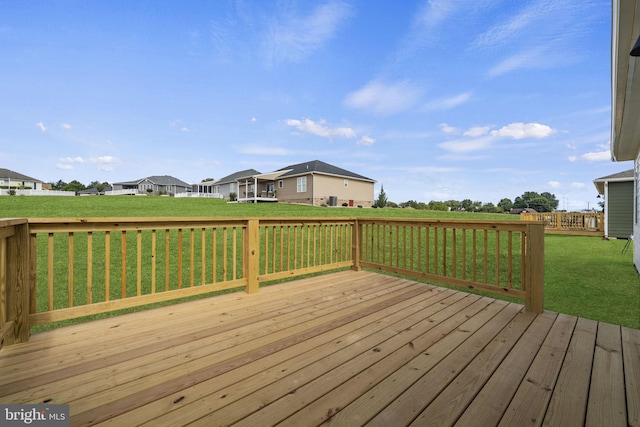 wooden deck featuring a yard