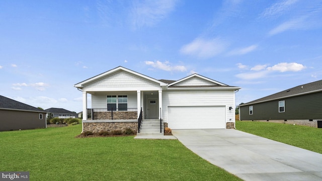 view of front of property featuring a garage, covered porch, and a front yard