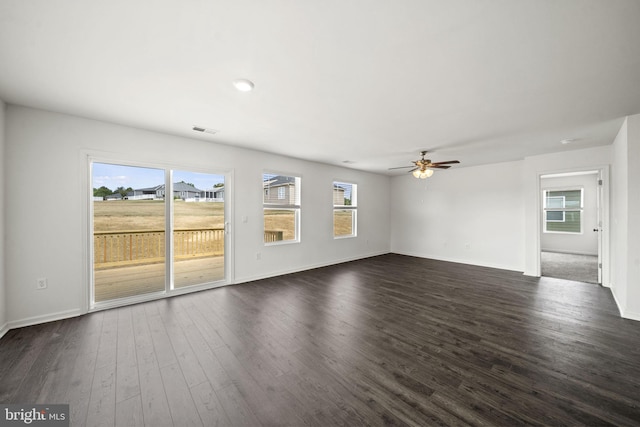 unfurnished living room with dark hardwood / wood-style floors and ceiling fan