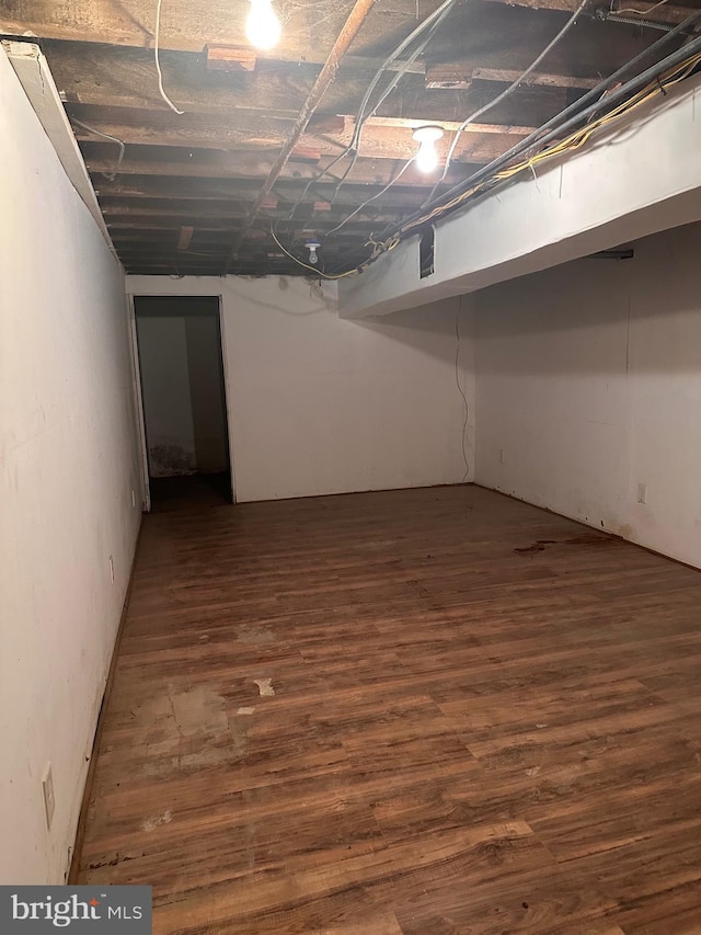 unfinished basement with dark wood-type flooring