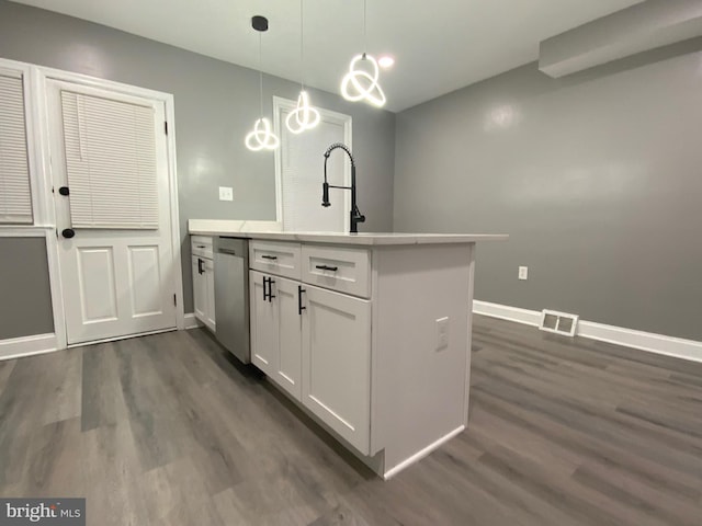 kitchen featuring dark wood-type flooring, white cabinetry, hanging light fixtures, stainless steel dishwasher, and kitchen peninsula