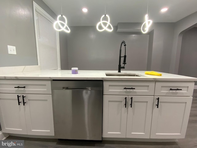 kitchen with dishwasher, hanging light fixtures, and white cabinets