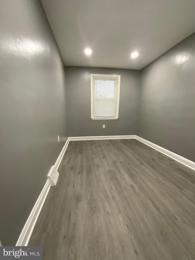 spare room featuring dark wood-type flooring