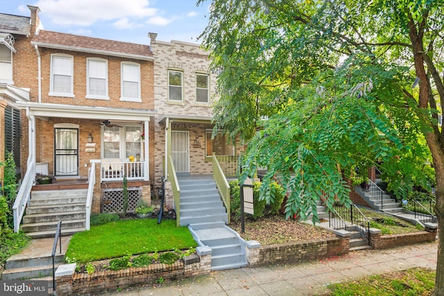 townhome / multi-family property featuring a porch