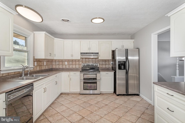 kitchen with stainless steel appliances, white cabinetry, and sink