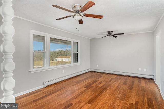 unfurnished room featuring hardwood / wood-style floors, crown molding, a baseboard radiator, and a textured ceiling